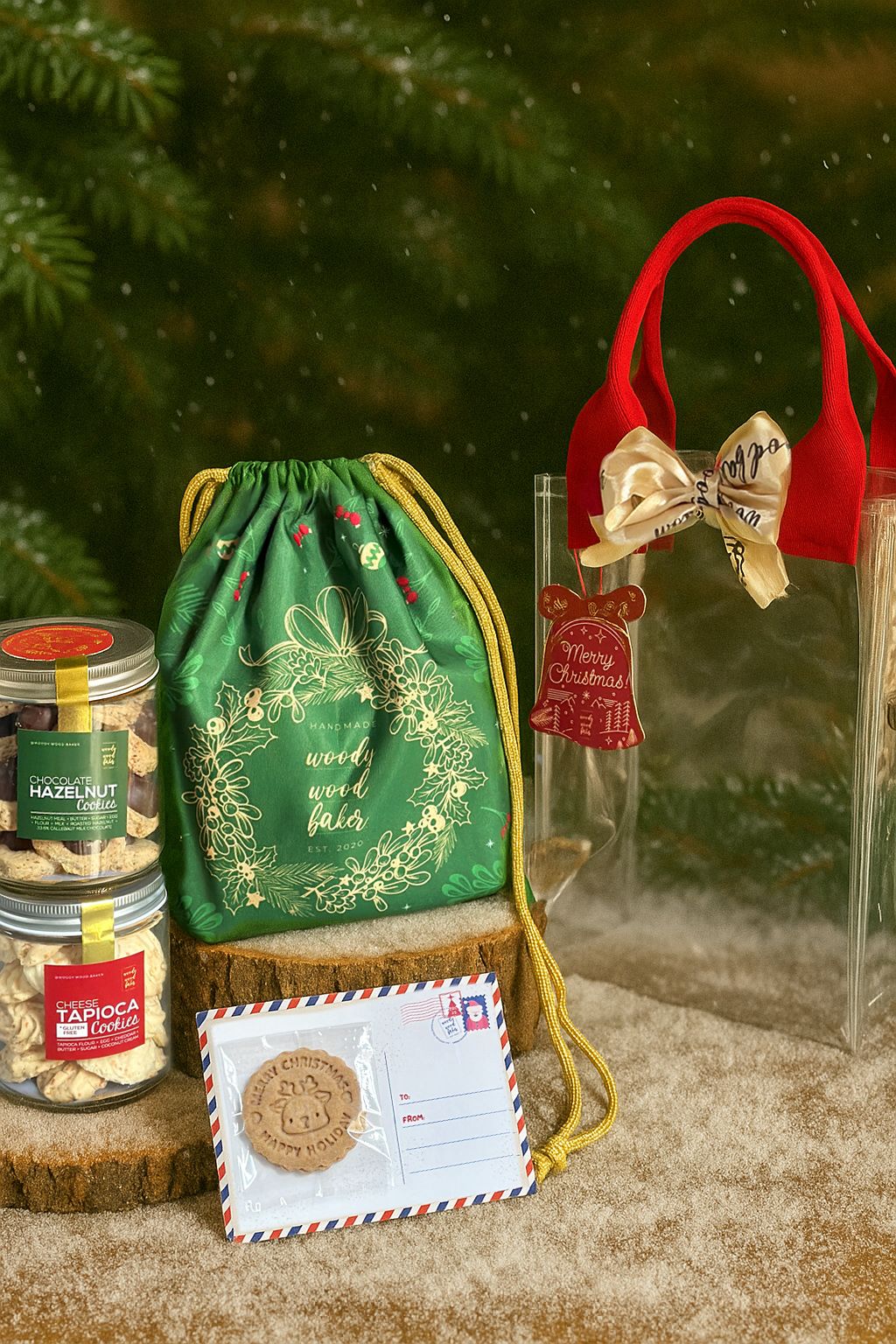 Two jars of cookies and a Cookiegram packed in a festive reusable pouch and bag for the Sacco di Babbo Natale hamper.