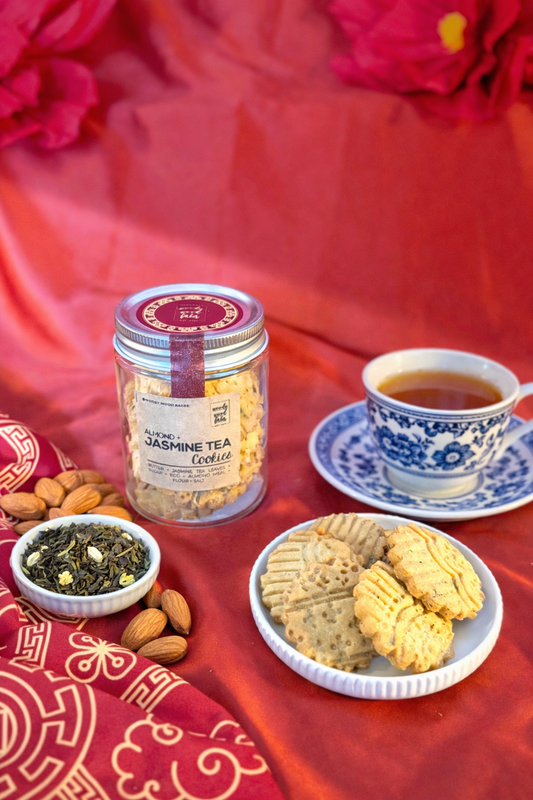 Almond jasmine butter cookies infused with jasmine tea leaves in glass jar